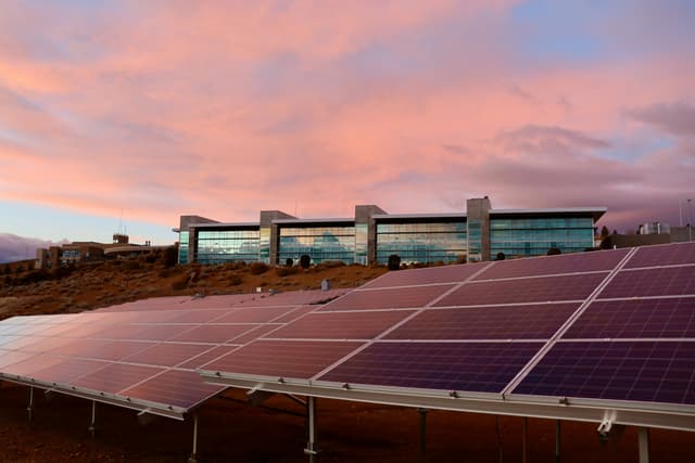 Commercial building with ground-mounted solar panel array