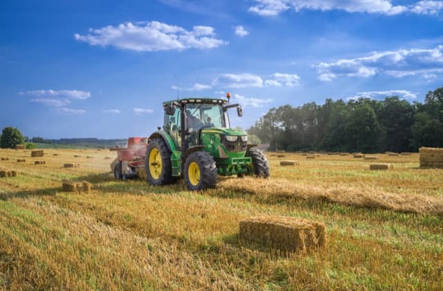 Tractor harvesting in a rural agricultural field